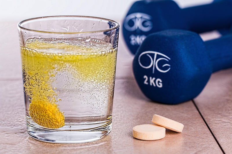 Effervescent electrolyte tablet dissolving in water glass — mineral supplement hydration